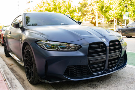 Miami, Florida, USA - July 12, 2025: Luxury car BMW M4 Competition. Car BMW M4 Competition parked outdoor. Black matte vehicle, corner view. 2022 BMW M4 Competition coupe carのeditorial素材