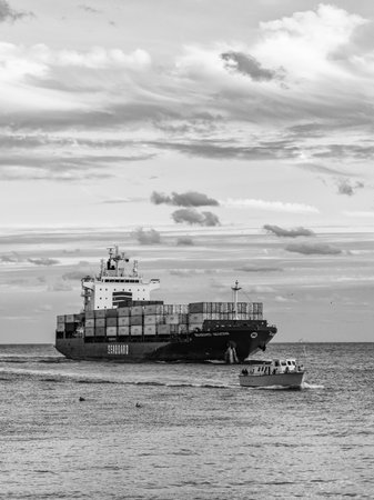 Miami, Florida, USA - January 03, 2025: Freight container loaded on cargo vessel. Drone view cargo...