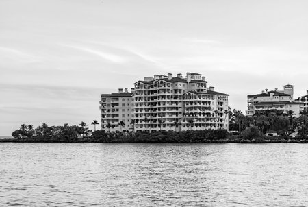 Fisher island building in sunset. Panorama sunset view of Fisher island, Miami. Miami beach sunrise sky. Miami panorama, Florida. Panoramic view of Fisher island. Sunrise panorama. Luxury apartmentの写真素材