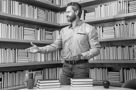 teachers day. millenial university student. education at school. school teacher in classroom. school library full of books. man tutor at bookstore. knowledge and education concept. private teachingの写真素材