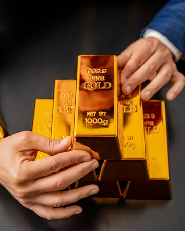 Golden bullion. Golden bar. Rich businessman save gold bullion. Financial fund success. Successful rich man with gold. Business success man with gold bar. Investment and saving. Saving motivationの写真素材