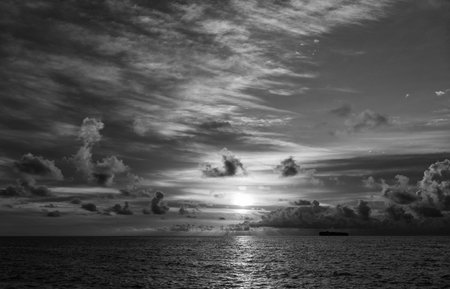 Skyscape with sea sunrise. Calm horizon at sea nature. Romantic summer vacation on beach seascape. Sunrise sky horizon. Sea sunset view. Cloudy sunset sky and seascape at summer vacationの写真素材