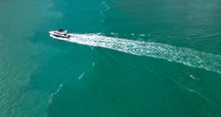 Vacation on summer. Summertime motorboat tour. Luxury motor boat yacht. Yacht go to marina. Boating and yachting. Luxury lifestyle. Marina yacht club aerial view. Yacht luxury view at seaの写真素材