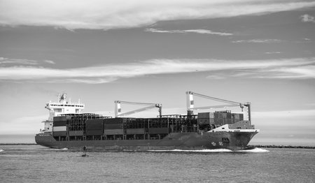 Cargo ship with container. Freight container loaded on cargo vessel. View of cargo ship navigating the sea leaving or entering harbor. Cargo business concept. Container shipの写真素材
