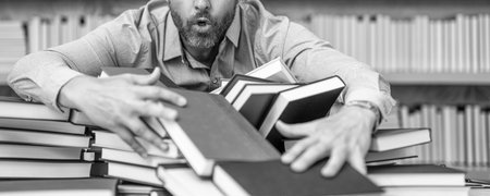 school professor reading books in library. teacher of literature school lesson. college teacher in classroom. school classroom full of books. school education for teacher or student. book stackの写真素材