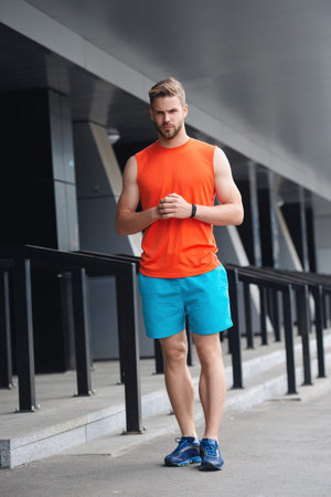 Runner man in sportswear. Fit and sporty man runner. Sportsman do sport. Fitness sportswear for man. Athletic lifestyle. Sport and fitness. Sportsman outdoor. Sport lifestyle. Activewear setの写真素材