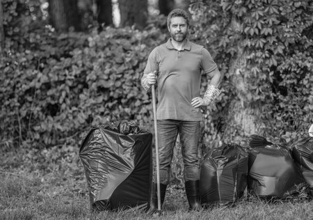 Environment plastic pollution. Volunteer man collecting garbage in forest. Environmental protection....