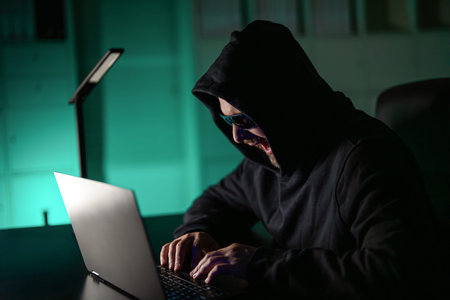 Hacker gamer at night in office. Cyber attack. Cyber criminal and stolen financial data. Digital...