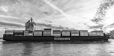 Miami, Florida, USA - January 03, 2025: Container ship in sunrise. Cargo ship Seaboard Genesis with...