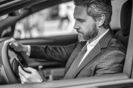Businessman dealer has phone call. Car insurance. Successful car dealer. Dealership. Man in suit...