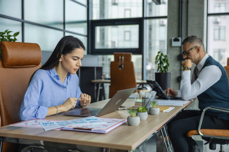 Busy businesspeople together in co-working space. Successful entrepreneur collaborating on new...