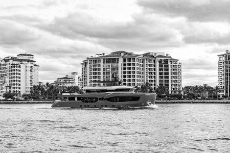 Miami canal with boat. View on Fisher island, Miami. Motor boat yacht floating to marina. Luxury...