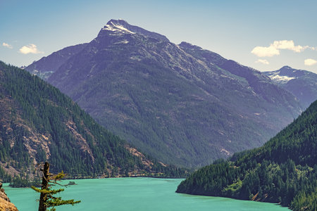 Landscape of mountain peak and Diablo lake. Nature landscape. Diablo Lake in North Cascades National Park. Scenic nature view over Diablo lake. Travel destination. Diablo lake with mountain landscapeの写真素材