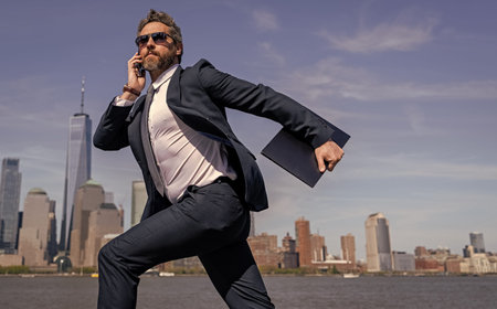 Businessman running to success. Business success. Successful businessman hurrying on New York city...