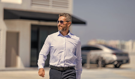 Successful business leader. Business success of businessman. Businessman leadership. Top manager walking. Rich man in sunglasses. Business success man outdoor. Businessman stylish portraitの写真素材