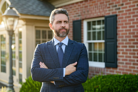 Successful confident broker make offer. Mortgage insurer. American sales manager. Real estate agent at house for sale. Realtor welcoming visitor. rent or buy new home. Home insureの写真素材