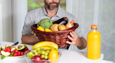 Morning at home. Breakfast in kitchen. Man eating vegetable and fruit. Enjoying healthy food. Man eat morning breakfast in kitchen. Man eating lunch, selective focusの写真素材
