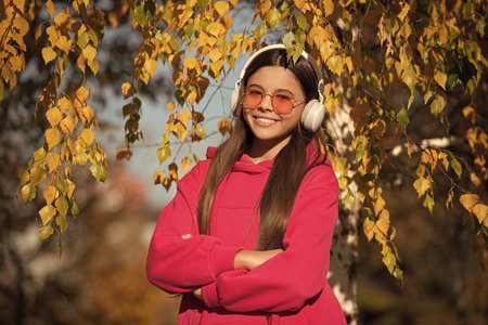 gen z concept. Youth gen lifestyle. Girl listen music. adolescent girl enjoying autumn nature. girl...
