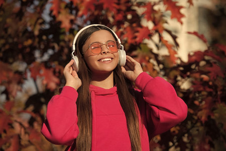Girl with headphones outdoor. Girl in autumn park. Music lifestyle. Music break. Enjoy autumn...