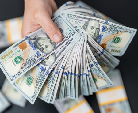 Business success man hold dollar. Millionaire hold dollar money. Riches and success. Rich...