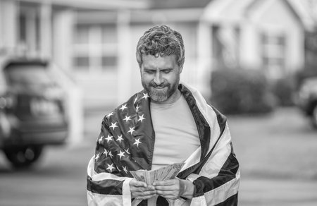 Paying tax in America. Value added tax. Taxation system. Patriotic man counting money. Man with...