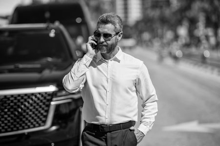Businessman using phone. Business call. Man phone conversation. Mature Hispanic business man with...