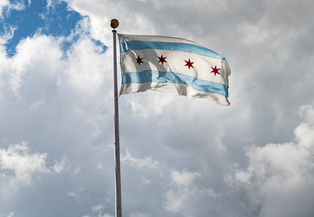 Chicago flag waving at wind at sky. Flag of Chicago city. Four stars symbol waving in the wind. Flag...