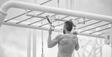 Strong athlete. Man pullup. Muscular man sportsman with strong back muscle. Sport pullup workout....