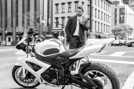 Hispanic businessman dealer. Rich man customer buyer choose bike. Buy or sell motorbike. Dealership...