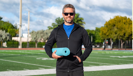 Yoga coach. Sport man ready for workout. Healthy lifestyle. Fitness and sport. Yoga mat for...