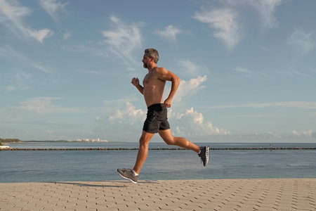 Healthy lifestyle. Sportsman running in summer. Sport runner do workout. Sport lifestyle with...