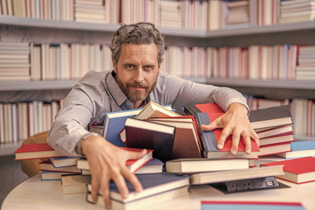 bookworm teacher at lesson or exam. man book lover in library. school teacher brainstorm in...