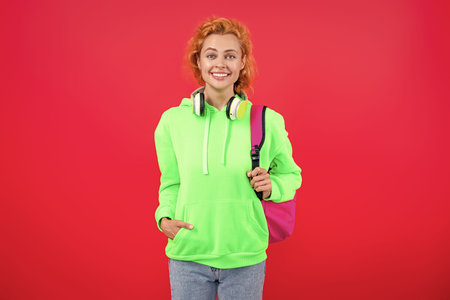 School education. Students life. Young woman isolated on red. September 1. Study in college. Student...