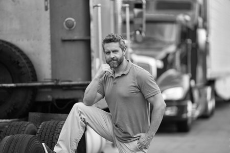 Trucking owner. Transportation vehicles. Hispanic man at his truck. Semi trucks vehicle. Man owner truck driver. Transportation industry. Man driver near lorry truck. Truck driver. Owner operatorの写真素材