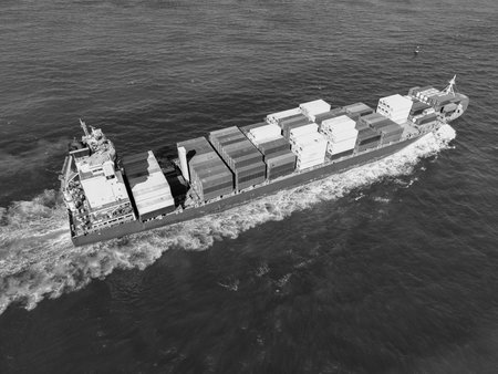 Aerial view cargo ship facing sea. Cargo business. Container ship. Shipping logistics. Commercial...
