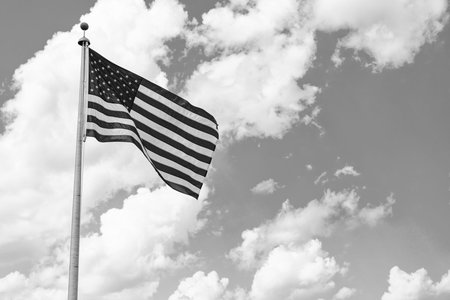 Flag of the USA. National waving flag of united states on blue sky. Independence day. Patriotic...