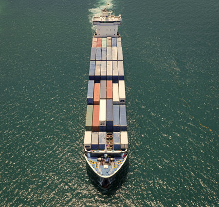 Commercial shipping. Cargo ship in sea, aerial view. Freight container loaded on cargo vessel....