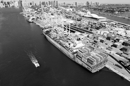 Miami, Florida, USA - March 20, 2025: Cargo ship vessel. Miami port. Container export ship. Cargo...