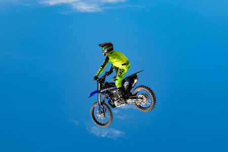 Miami, Florida, USA - May 25, 2025: Motocross rider performing stunt. Motocross rider performing...