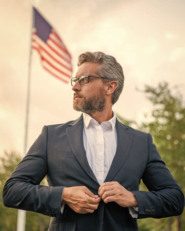 Business success man outdoor. Man in business suit at American flag. Businessman in suit. Successful businessman. Business success. Big boss before meeting. Successful leadership