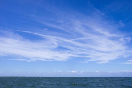 Dynamic clouds on a blue sky over North Sea panoramaの写真素材