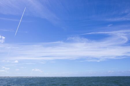 Dynamic clouds on a blue sky over North Sea panoramaの写真素材