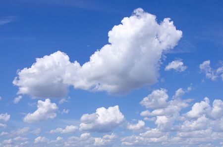 Panorama of fluffy sheep clouds against a blue skyの写真素材