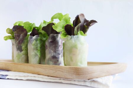 Vegetable salad roll on wood tray. Selective focus. Copy space. Still life. Healthy salad. Mix salad.の写真素材