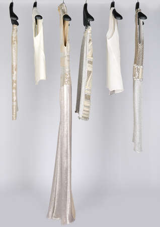 Sets of elegant and trendy women's clothes hanging in a shop for sale.の写真素材