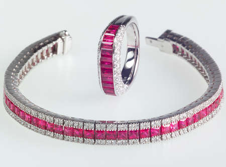 Unhooked expensive bracelet with precious stone ring with the same features. Macro shot with selective focus.の写真素材