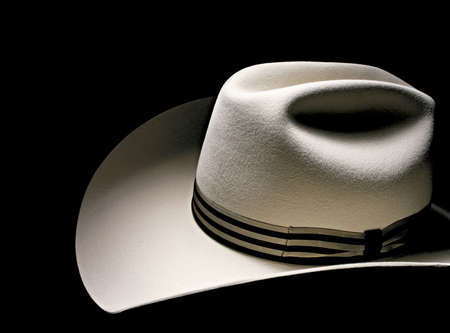 Elegant Italian handmade men's hat decorated with leather isolated on black. Macro studio shot.の写真素材