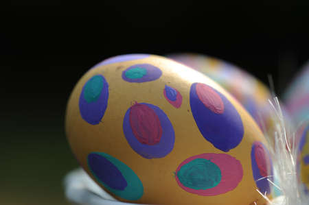 Group of hand painted Easter eggs in a ceramic bowl. Selective focus.
