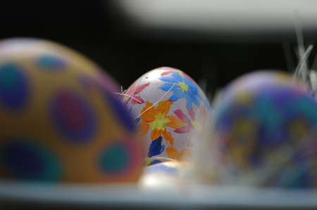 Group of hand painted Easter eggs in a ceramic bowl. Selective focus.