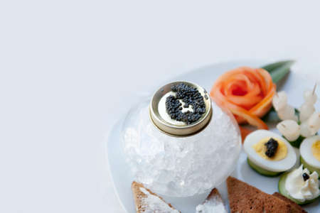 Luxury appetizers with caviar, eggs, onions and slices of bread.の写真素材